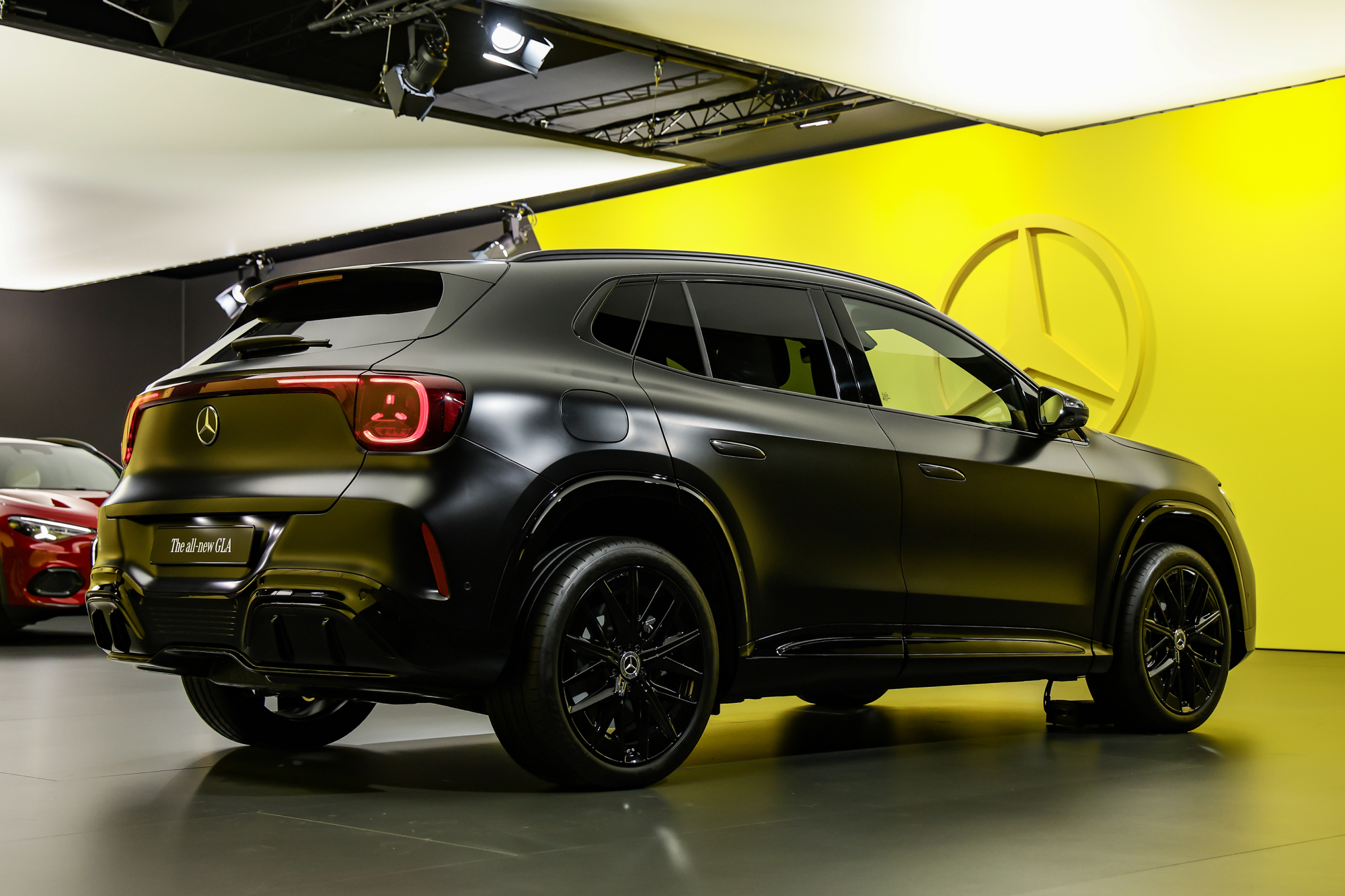 electric compact premium SUV silhouette on open road at dawn