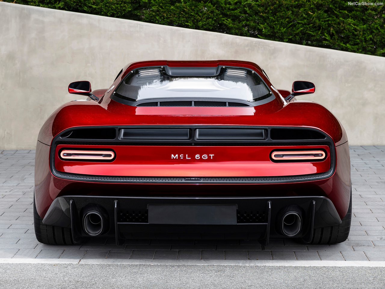 two grand touring sports cars parked side by side comparison mood